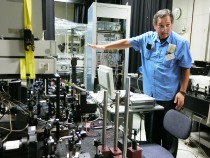 半導体レーザーの実験装置について解説する秋山教授